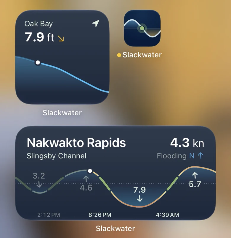 An iPhone home screen with two Slackwater widgets: Oak Bay's tide at 7.9 feet and falling, and Nakwakto Rapids flooding north at 4.3 knots with the day's maximums and slacks on its curve.